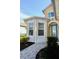 Attractive yellow home with bay window and a blue front door at 240 Blue Starfish Pl, Daytona Beach, FL 32124