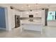 Modern kitchen with white cabinets, stainless steel appliances, and large island at 240 Blue Starfish Pl, Daytona Beach, FL 32124