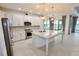 Modern kitchen with white cabinets, granite countertops, and stainless steel appliances at 240 Blue Starfish Pl, Daytona Beach, FL 32124