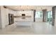 Bright kitchen features white cabinets, stainless steel appliances, pendant lighting, and a center island at 240 Blue Starfish Pl, Daytona Beach, FL 32124