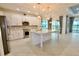 Modern kitchen with white cabinets, granite countertops, and stainless steel appliances at 240 Blue Starfish Pl, Daytona Beach, FL 32124