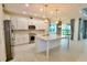 Modern kitchen with white cabinets, granite countertops, and stainless steel appliances at 240 Blue Starfish Pl, Daytona Beach, FL 32124