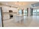 Modern kitchen with white cabinets, granite countertops, and stainless steel appliances at 240 Blue Starfish Pl, Daytona Beach, FL 32124