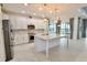 Modern kitchen with white cabinets, granite countertops, and stainless steel appliances at 240 Blue Starfish Pl, Daytona Beach, FL 32124
