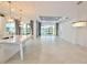 Open-concept living area with a kitchen island, recessed lighting, and large windows at 240 Blue Starfish Pl, Daytona Beach, FL 32124