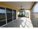 Bright screened patio with sliding glass doors and a ceiling fan at 240 Blue Starfish Pl, Daytona Beach, FL 32124