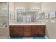 Double vanity bathroom with modern light fixtures and plenty of storage at 2522 Tree Meadow Loop, Apopka, FL 32712