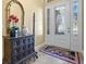 Bright entryway with decorative mirror and console table at 2522 Tree Meadow Loop, Apopka, FL 32712