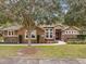 Single-story home with stone accents and landscaped yard at 2522 Tree Meadow Loop, Apopka, FL 32712