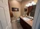 Cozy bathroom featuring decorative towels and a traditional vanity and mirror at 2544 Ashville Ave, The Villages, FL 32162
