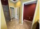 A clean bathroom area with a toilet and storage closet, as well as a shower with tile walls at 2544 Ashville Ave, The Villages, FL 32162