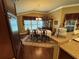 Formal dining room features a wood table with seating, elegant china cabinet, and beautiful flooring at 2544 Ashville Ave, The Villages, FL 32162