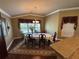 Elegant dining room with chandelier, large window, and decorative accents at 2544 Ashville Ave, The Villages, FL 32162