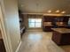 Spacious eat-in kitchen features custom cabinets, a center island and tile floors at 2544 Ashville Ave, The Villages, FL 32162