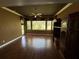 Bright living room with hardwood floors, large windows, and custom built-ins at 2544 Ashville Ave, The Villages, FL 32162