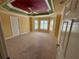 Spacious main bedroom featuring neutral carpet, bay windows, and a ceiling fan at 2544 Ashville Ave, The Villages, FL 32162