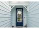 Navy blue front door with glass panels and white trim at 260 Blue Starfish Pl, Daytona Beach, FL 32124