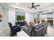 Relaxing living room with black leather couches and large TV at 260 Blue Starfish Pl, Daytona Beach, FL 32124