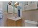 Bathroom with light wood vanity, shower, and a white toilet at 2858 N Powers Dr # 123, Orlando, FL 32818