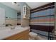 Clean bathroom with a vanity, toilet, and striped shower curtain at 2858 N Powers Dr # 123, Orlando, FL 32818