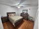 Bedroom with a double bed, wooden dresser, and nightstands at 2858 N Powers Dr # 123, Orlando, FL 32818