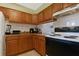 Kitchen boasts wood cabinets, a white stove, and a refrigerator at 2858 N Powers Dr # 123, Orlando, FL 32818