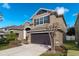 Charming two-story home featuring a two-car garage, well-maintained landscaping, and classic architectural details at 2874 Pewter Mist Ct, Oviedo, FL 32765