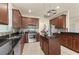 Modern kitchen with stainless steel appliances, dark wood cabinets, and a center island at 2874 Pewter Mist Ct, Oviedo, FL 32765