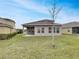 Private backyard with grassy area and covered patio at 2943 Top Water Way, Kissimmee, FL 34746