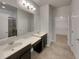 Double vanity bathroom with large mirror and walk-in shower at 2943 Top Water Way, Kissimmee, FL 34746