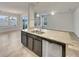 Island kitchen with granite countertops and double sink at 2943 Top Water Way, Kissimmee, FL 34746