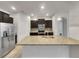 Modern kitchen with stainless steel appliances and granite countertops at 2943 Top Water Way, Kissimmee, FL 34746