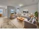 Bright living room featuring comfy seating and large windows at 2943 Top Water Way, Kissimmee, FL 34746