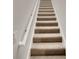 Carpeted staircase with white railing at 2943 Top Water Way, Kissimmee, FL 34746