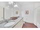 Elegant bathroom with double sinks, granite countertop, and a separate tub and shower at 2956 Lucayan Harbour Cir # 107, Kissimmee, FL 34746
