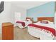 Bedroom with two twin beds, nightstands, and a dresser at 2956 Lucayan Harbour Cir # 107, Kissimmee, FL 34746
