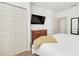 Cozy bedroom with a king-size bed, dresser, and double doors at 2956 Lucayan Harbour Cir # 107, Kissimmee, FL 34746