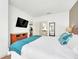 Spacious bedroom with a king-size bed, dresser, and a view of the kitchen at 2956 Lucayan Harbour Cir # 107, Kissimmee, FL 34746