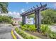 Lucaya Village entrance with a beautiful pergola and landscaping at 2956 Lucayan Harbour Cir # 107, Kissimmee, FL 34746