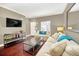 Living room boasts hardwood floors, neutral decor, and comfortable seating for relaxation at 2956 Lucayan Harbour Cir # 107, Kissimmee, FL 34746