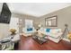 Bright living room features hardwood floors, comfy sofas, and a large flat-screen TV at 2956 Lucayan Harbour Cir # 107, Kissimmee, FL 34746