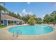 Community pool with surrounding lounge chairs and lush greenery at 2956 Lucayan Harbour Cir # 107, Kissimmee, FL 34746