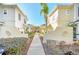 Pathway between the townhouses with lush greenery on either side at 2956 Lucayan Harbour Cir # 107, Kissimmee, FL 34746