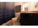 Clean bathroom with dark vanity and patterned shower curtain at 3428 Calabria Ave, Davenport, FL 33897