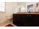 Bathroom with dark wood cabinets and granite countertop at 3428 Calabria Ave, Davenport, FL 33897
