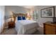 Well-lit bedroom with a full-size bed and bamboo-style furniture at 3428 Calabria Ave, Davenport, FL 33897