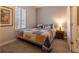 Cozy bedroom featuring a full-size bed and a window with plantation shutters at 3428 Calabria Ave, Davenport, FL 33897