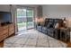 Living room with a brown leather couch and sliding glass door at 3428 Calabria Ave, Davenport, FL 33897