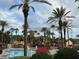 Another view of the pool area with palm trees and resort amenities at 3428 Calabria Ave, Davenport, FL 33897