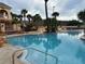 Close-up view of the pool with a clear blue water and a water slide feature at 3428 Calabria Ave, Davenport, FL 33897